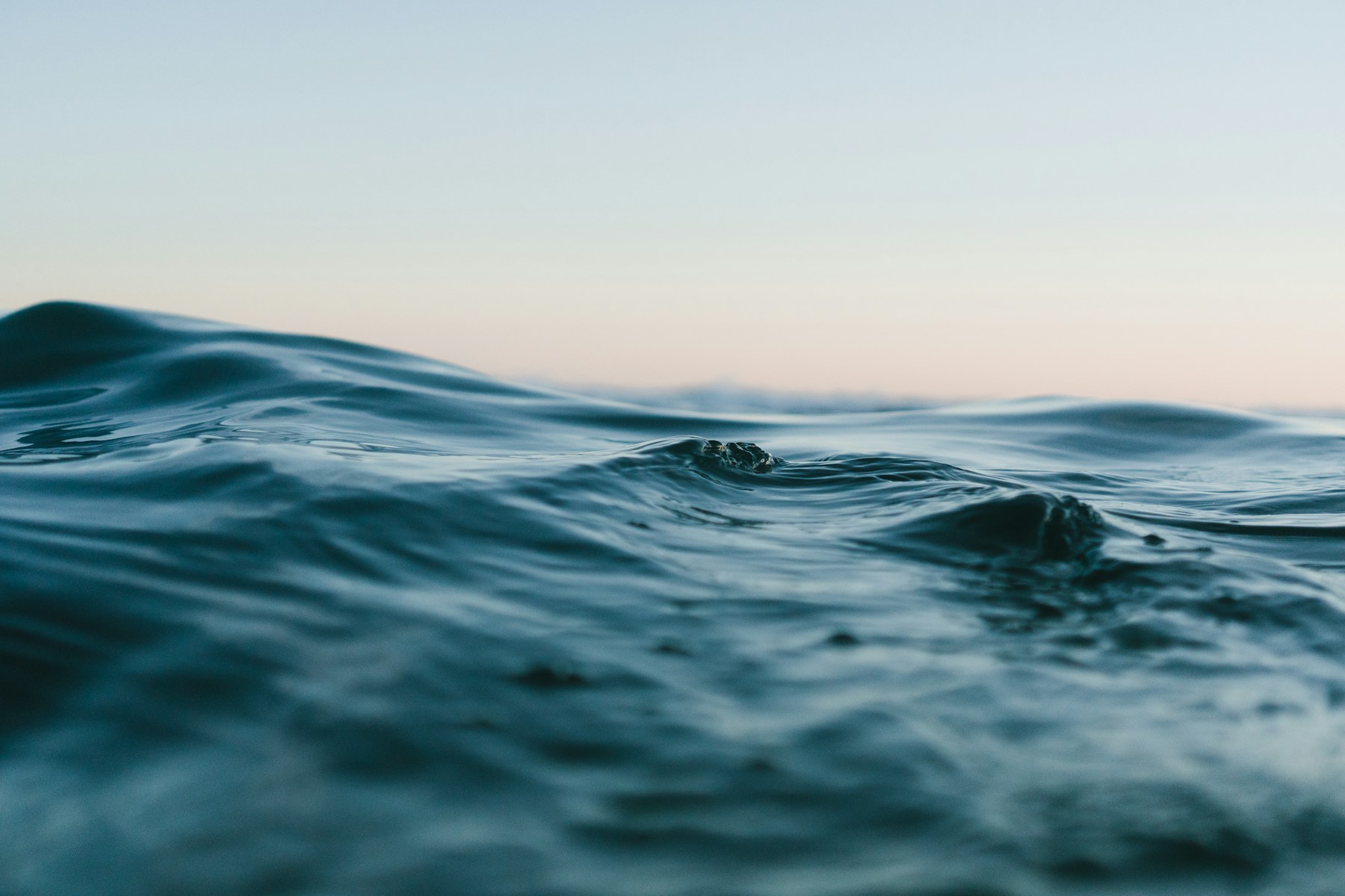 Soft ocean waves in blue and warm evening light